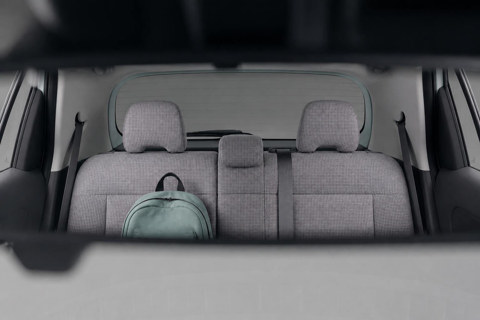 Asientos traseros del Inster vistos desde el retrovisor interior con una mochila sobre la banqueta
