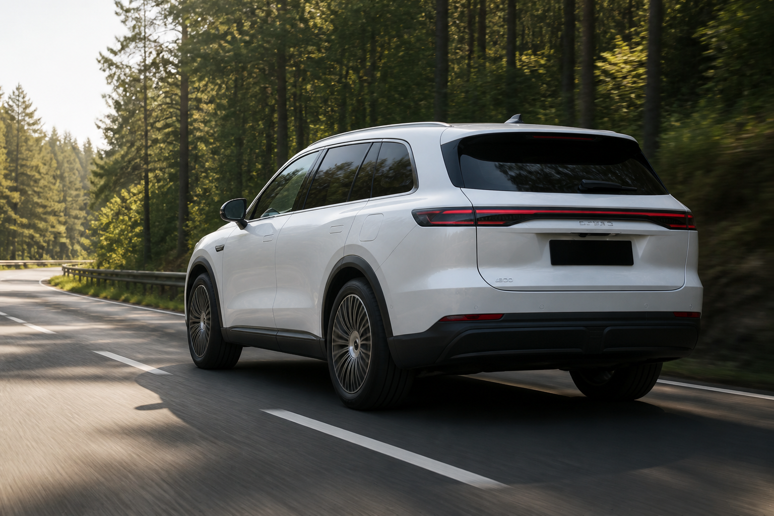 Ebro S900 blanco circulando por una carretera entre bosque verde con luz de mañana