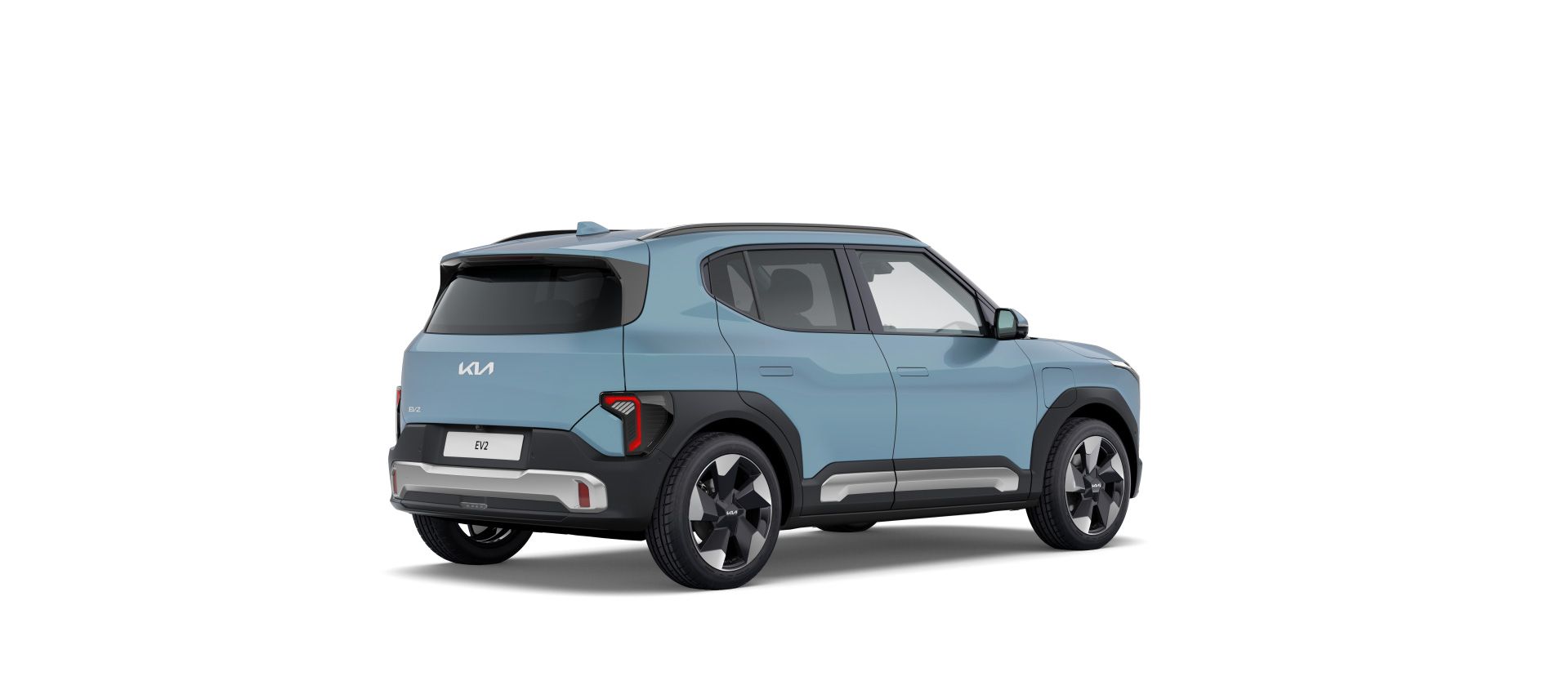 Render de estudio de un Kia EV2 en azul claro, visto de tres cuartos trasero, sobre fondo blanco.
