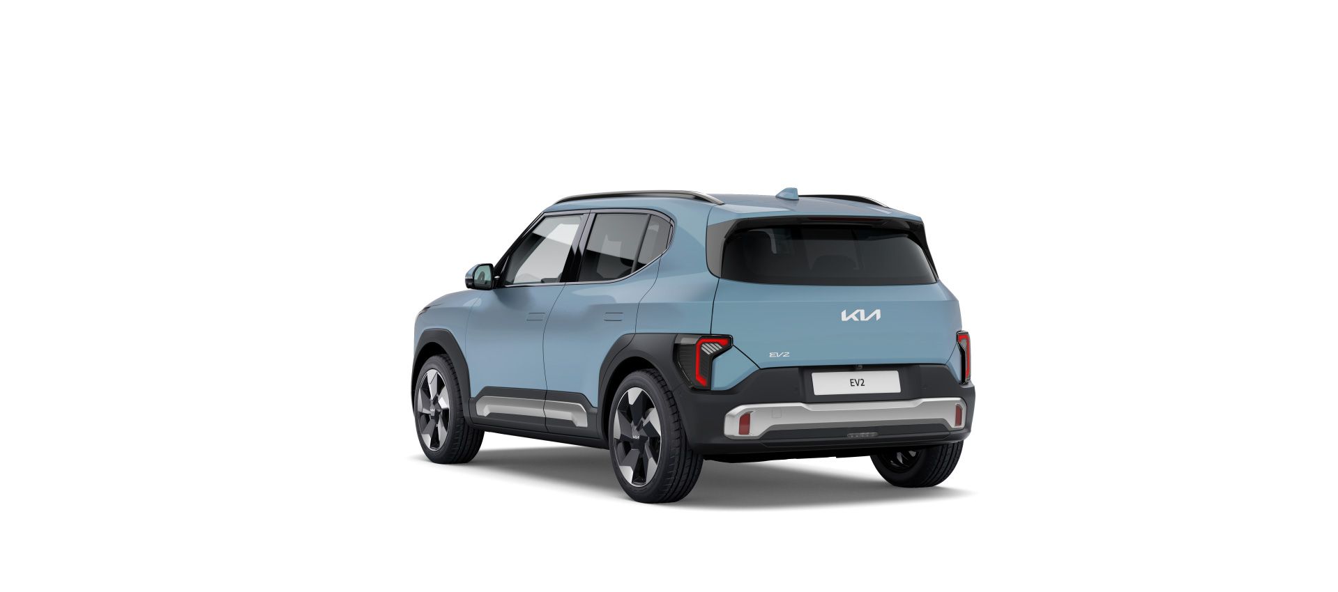 El Kia EV2 en vista trasera de tres cuartos, mostrando su diseño compacto y llantas multirradio.