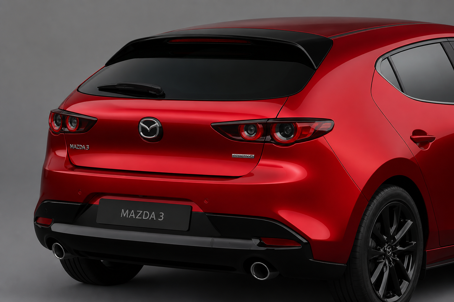 Primer plano del alerón de techo y los faldones en negro brillante sobre la zaga del hatchback rojo