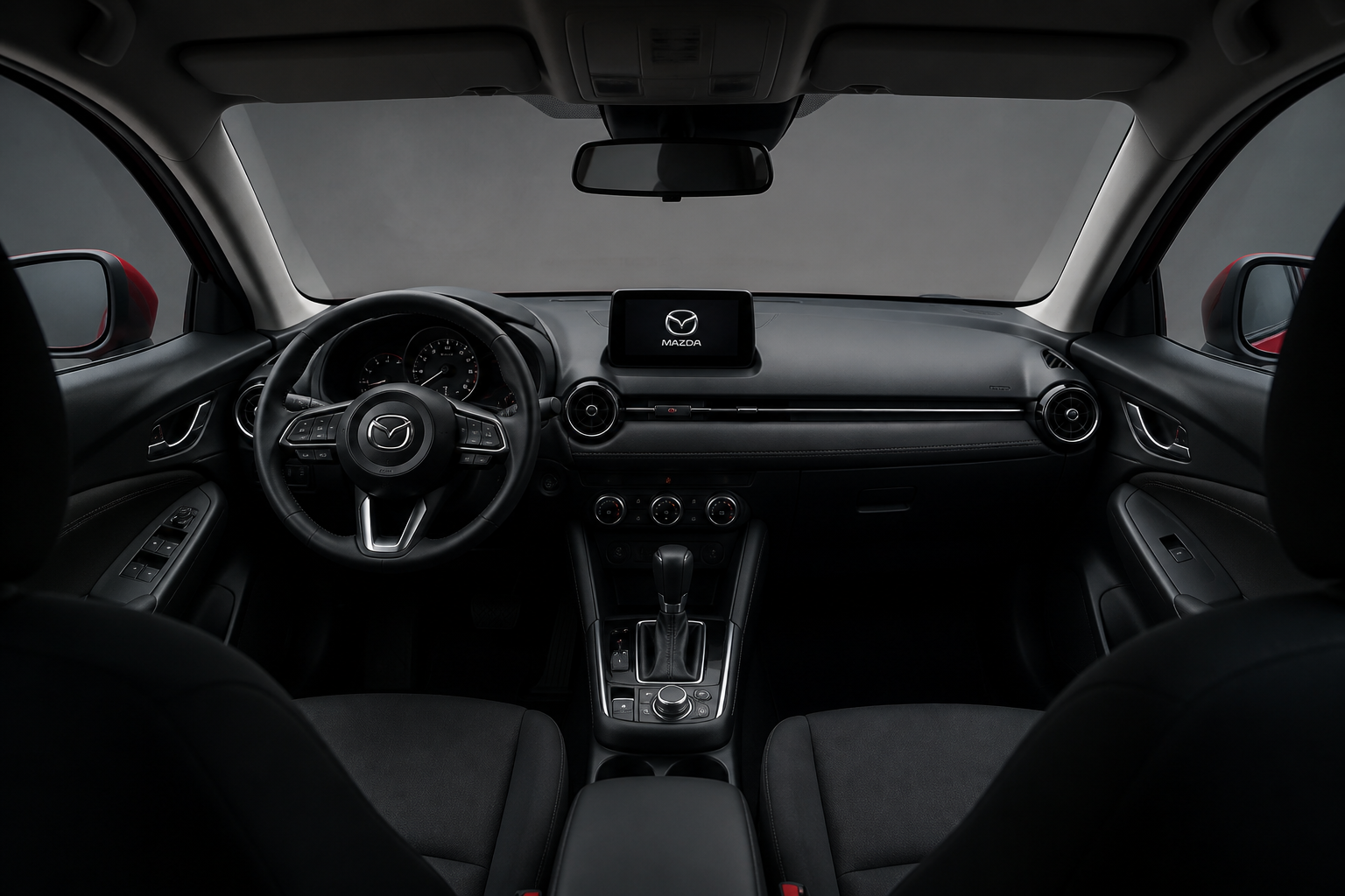 Habitáculo sereno del Mazda3 visto desde atrás, con luz suave entrando por el parabrisas