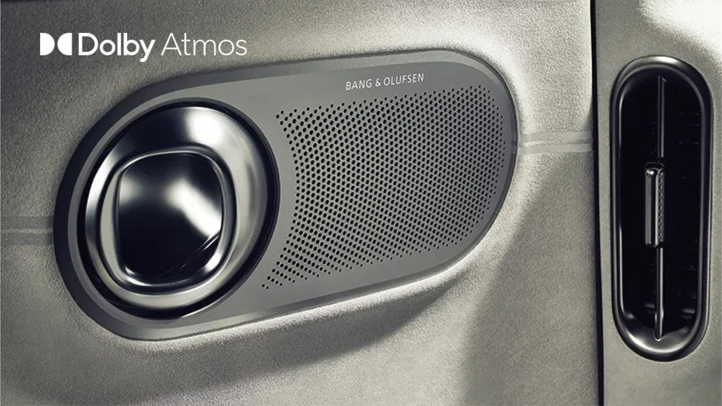 Altavoz Bang & Olufsen y rejilla de ventilación en el panel de puerta, con el logotipo Dolby Atmos visible