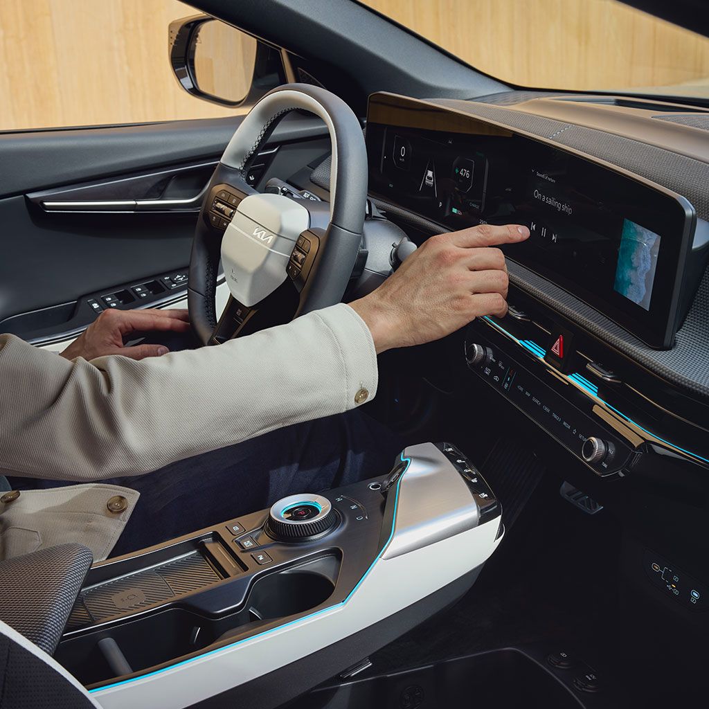 Conductor interactuando con la pantalla multimedia curvada del EV6